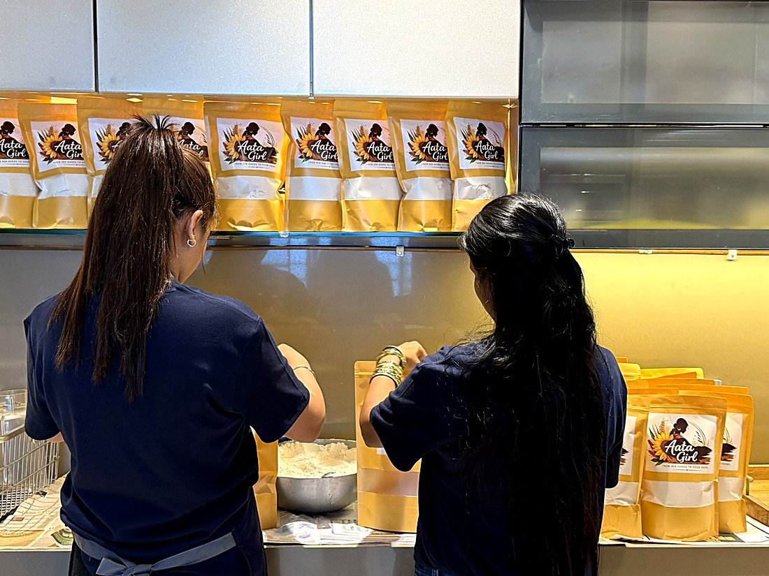 Packing atta into bags at the counter