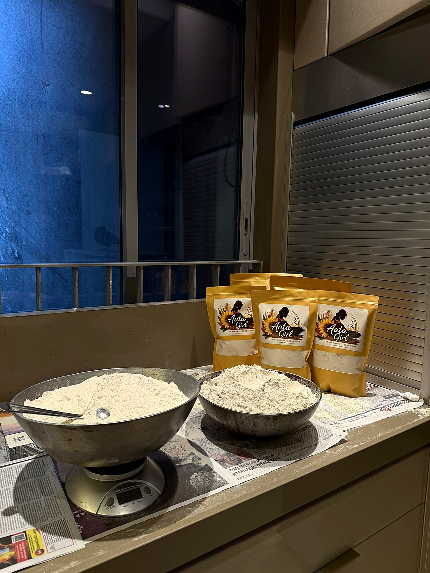 Bowls of freshly milled atta with packaged bags